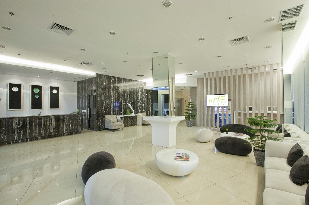 Whiz Hotel Cikini lobby and guest room